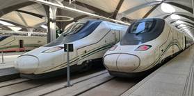 A couple of trains in a station

Description automatically generated